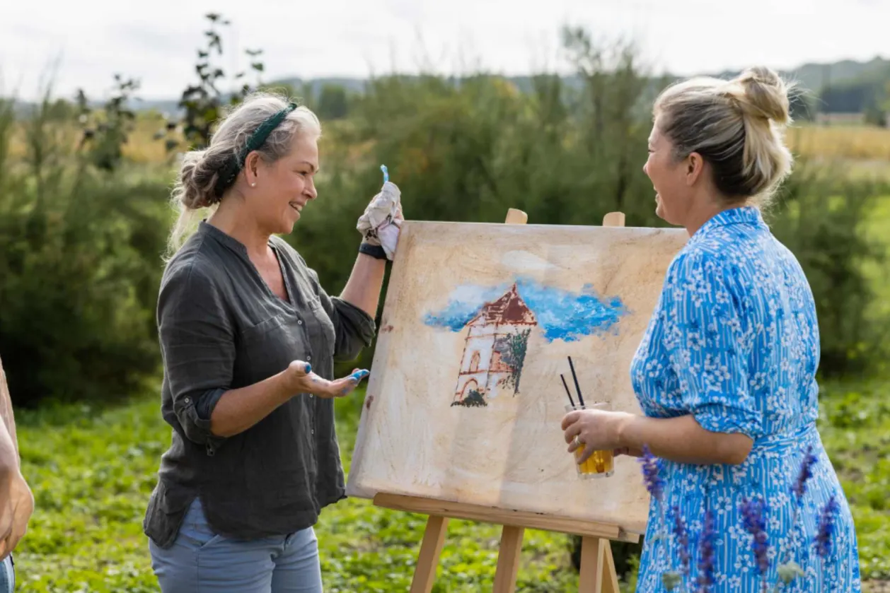 Mature woman participating in an art class in France while on a creative wellness retreat